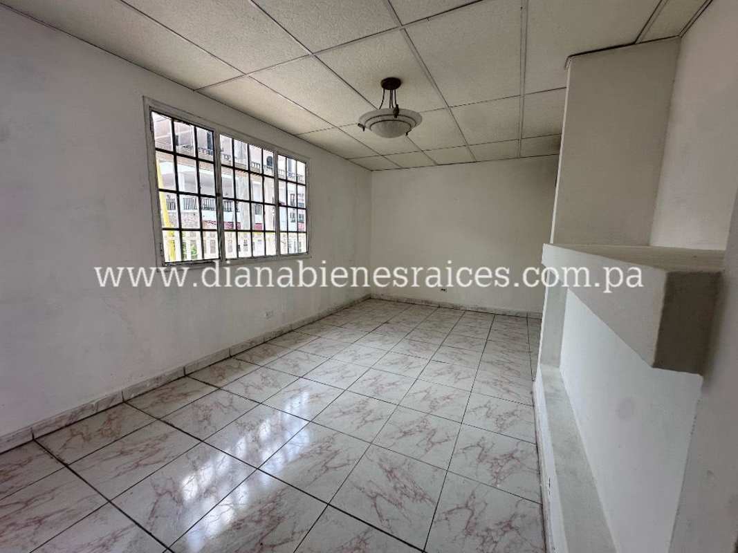 Spacious unfurnished living room with granite floors and large windows in Villas de las Fuentes Panama City