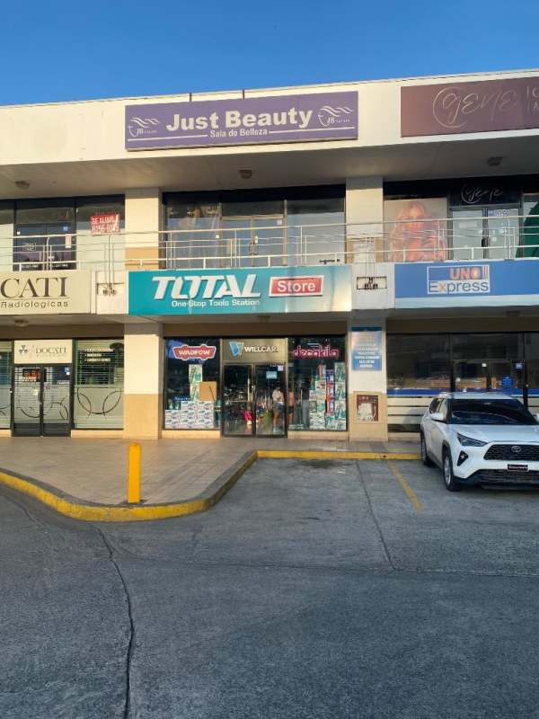 Commercial plaza with parking spaces storefronts and balconies Plaza Los Andes Panama City