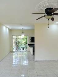 Open plan living dining space with tile floors and neutral decor at Residencial Howard Panama Pacifico