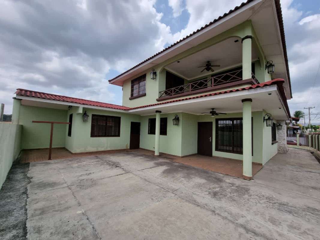 Spacious living room with large windows ceiling fans recessed lighting ceramic tile in house for sale Brisas del Golf Panama