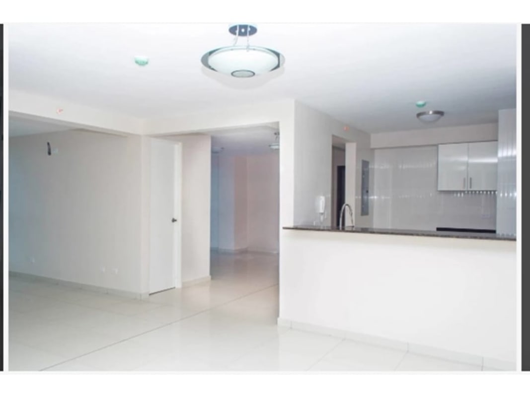 Laundry area equipped with stacked washer dryer and kitchen with modern appliances PH Bela Vita Bella Vista Panama