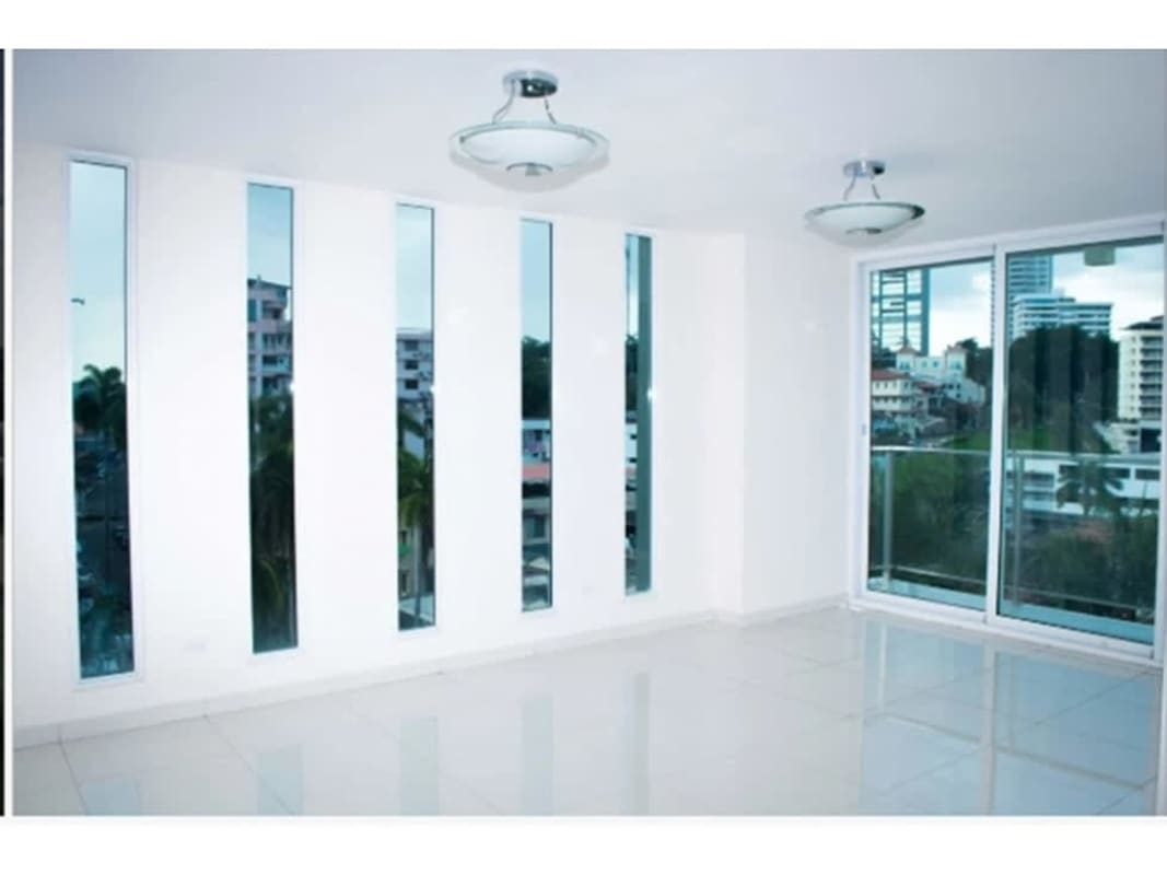 Living space with floor-to-ceiling windows and sliding door balcony in PH Bela Vita