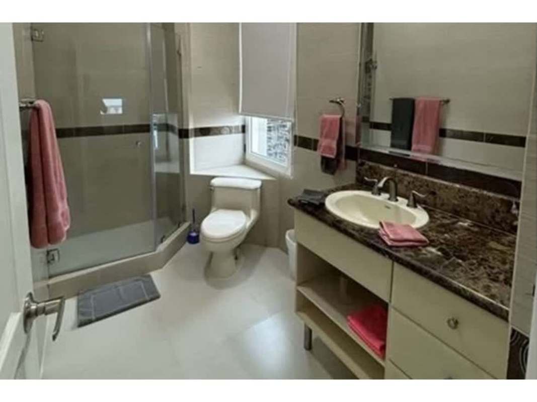 Bathroom with marble vanity, glass shower and window in Vista del Mar Panama