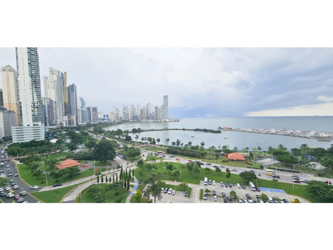 Stylish balcony with glass rails overlooking ocean and skyline at Avenida Balboa Panama