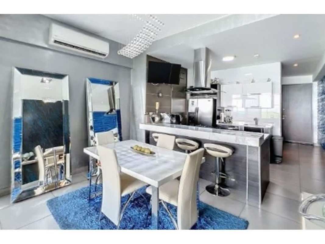 Modern master bedroom in PH Element Tower with walk-in closet, large windows overlooking city Panama