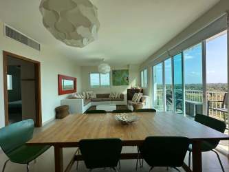 Kitchen with breakfast counter, modern cabinetry in oceanfront condo at PH Bijao Cocoli Panama