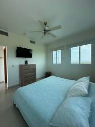 Master bedroom with large windows overlooking ocean at PH Bijao Cocoli Río Hato Panama