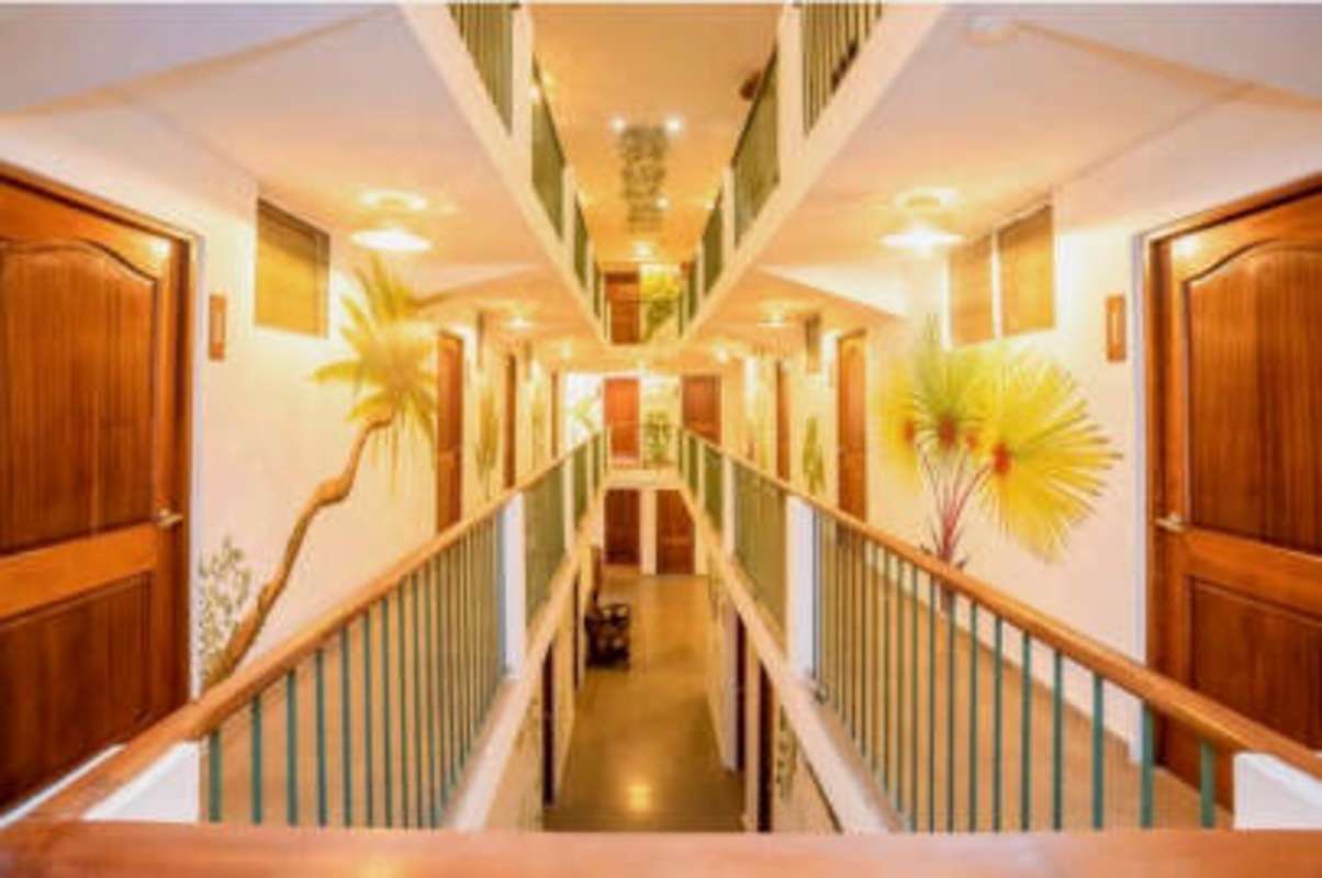 Modern guest room with air conditioning, queen bed, wall art, minimalist furniture in Casco Antiguo hotel