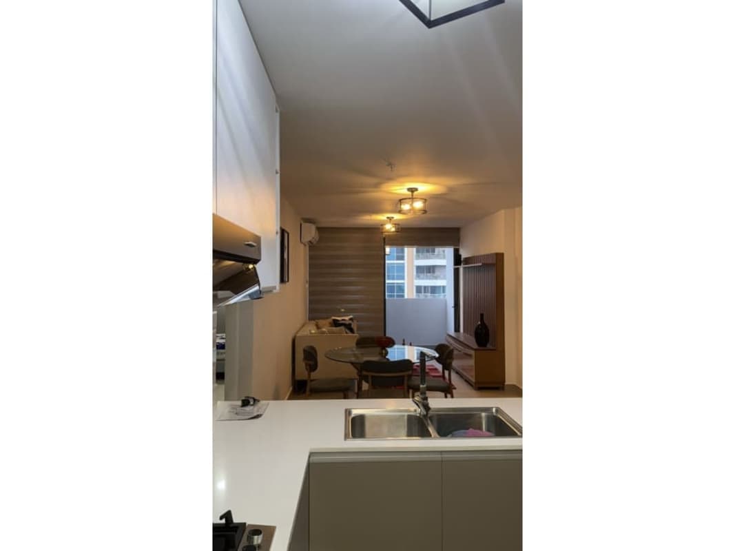 Open-plan modern dining and kitchen in furnished apartment in San Francisco Bay Panama