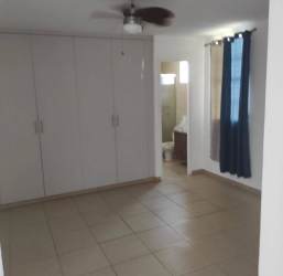Spacious bedroom with ceiling fan and ensuite bathroom in house for sale in Brisas de Arraiján Panama