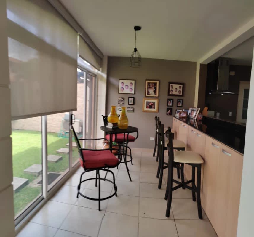 Landscaped backyard garden with tile patio in corner house Versalles Panama