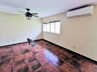 Bright living room with tiled floor, large windows Villas de Howard Panama Pacifico