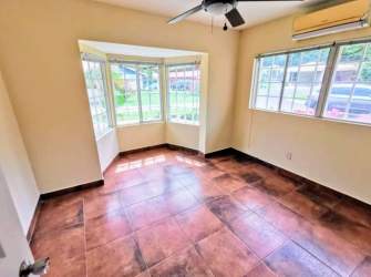 Bedroom with AC unit and large window Villas de Howard in Panama Pacifico