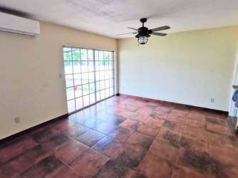 Spacious living room with sliding glass doors and AC in Villas de Howard Panama