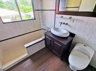Modern bathroom with window, mounted sink, tub Villas de Howard Panama Pacifico
