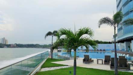 Modern bathroom with glass shower granite counters at Ocean Waves Gorgona condo Panama