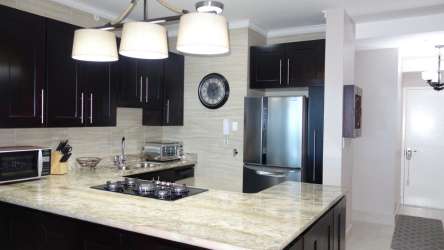 Modern beach condo kitchen with granite counters stainless appliances Ocean Waves Gorgona Panama