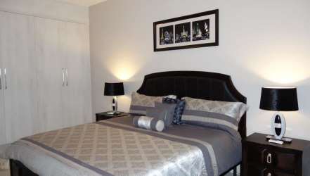 Beach condo furnished living room with smart lighting AC controls in Ocean Waves Panama