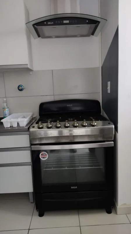 Kitchen area with gas stove refrigerator white cabinetry PH El Crisol Panama