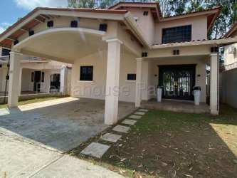 Front exterior of house with covered driveway and landscaped lawn in Sunset Hills Costa Verde Panama