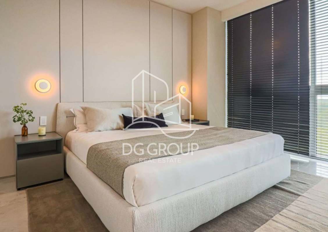 Master bedroom with floor-to-ceiling windows overlooking ocean and golf course