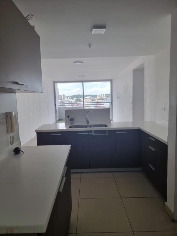 Modern kitchen with city view and large window at PH Residencial Herbruger El Carmen Panama