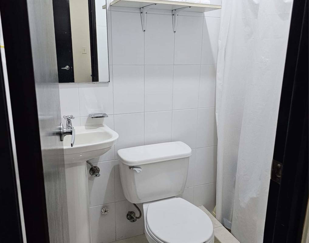 Bathroom featuring glass shower enclosure, tile walls in PH Dos Mares Residences Panama City