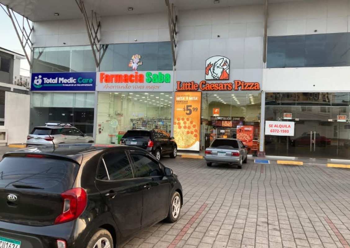 Multi-tenant shopping plaza with chain stores and client parking on Vía Parque Lefevre Panama City