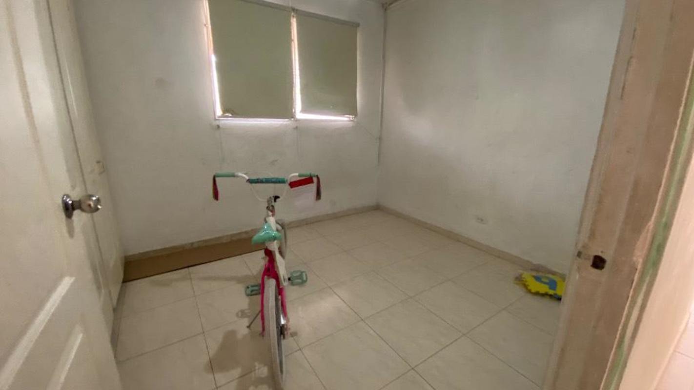 Minimalist bedroom with tiled floors, window blinds, white walls at Camino Real III San Antonio Panama