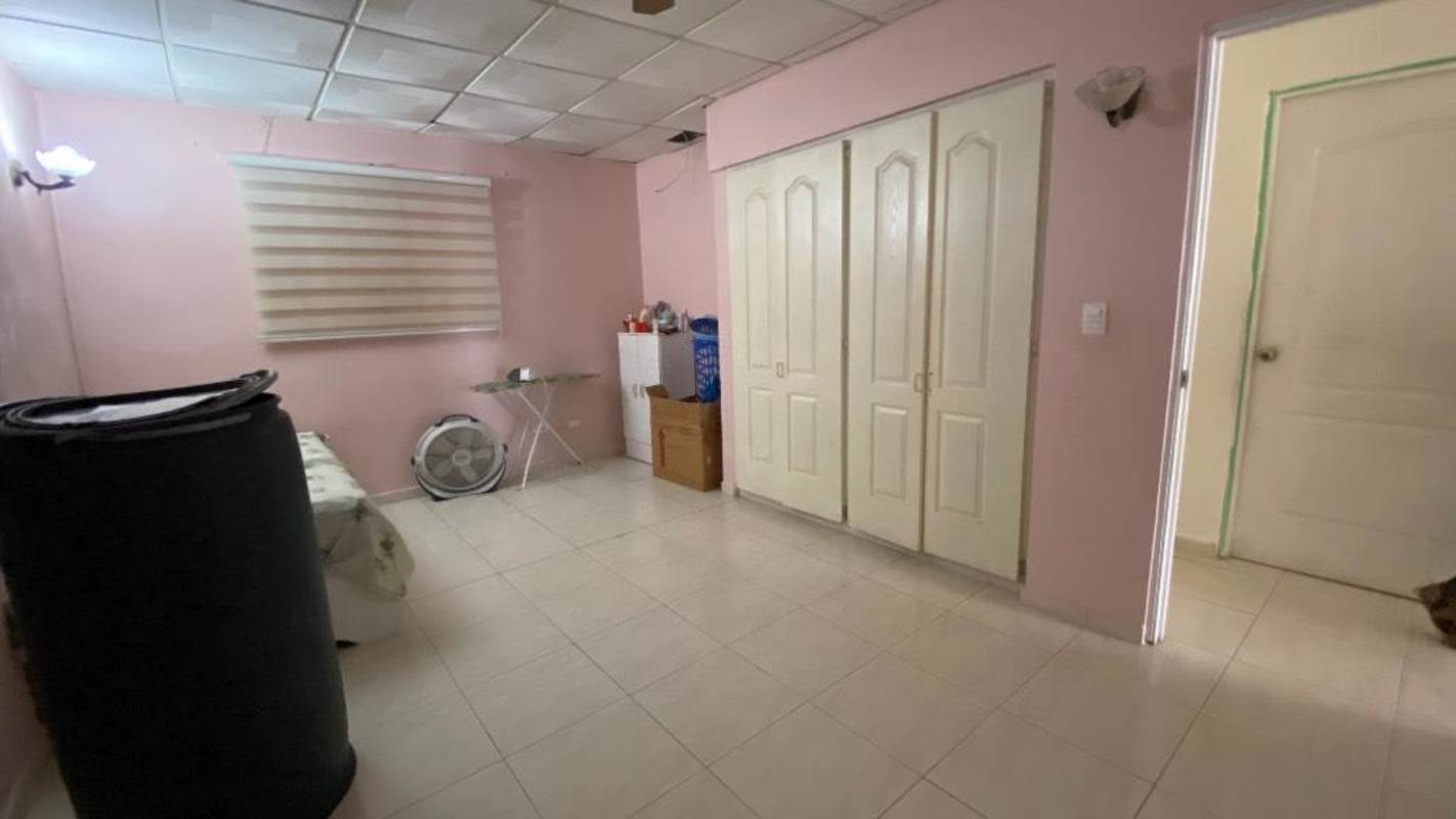 Bedroom interior pink walls, built-in closet and simple decor in Camino Real III Panama City