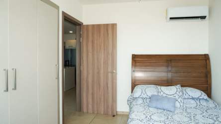 Bright bedroom with mountain and pool views in Royal Palm beachfront tower Nueva Gorgona