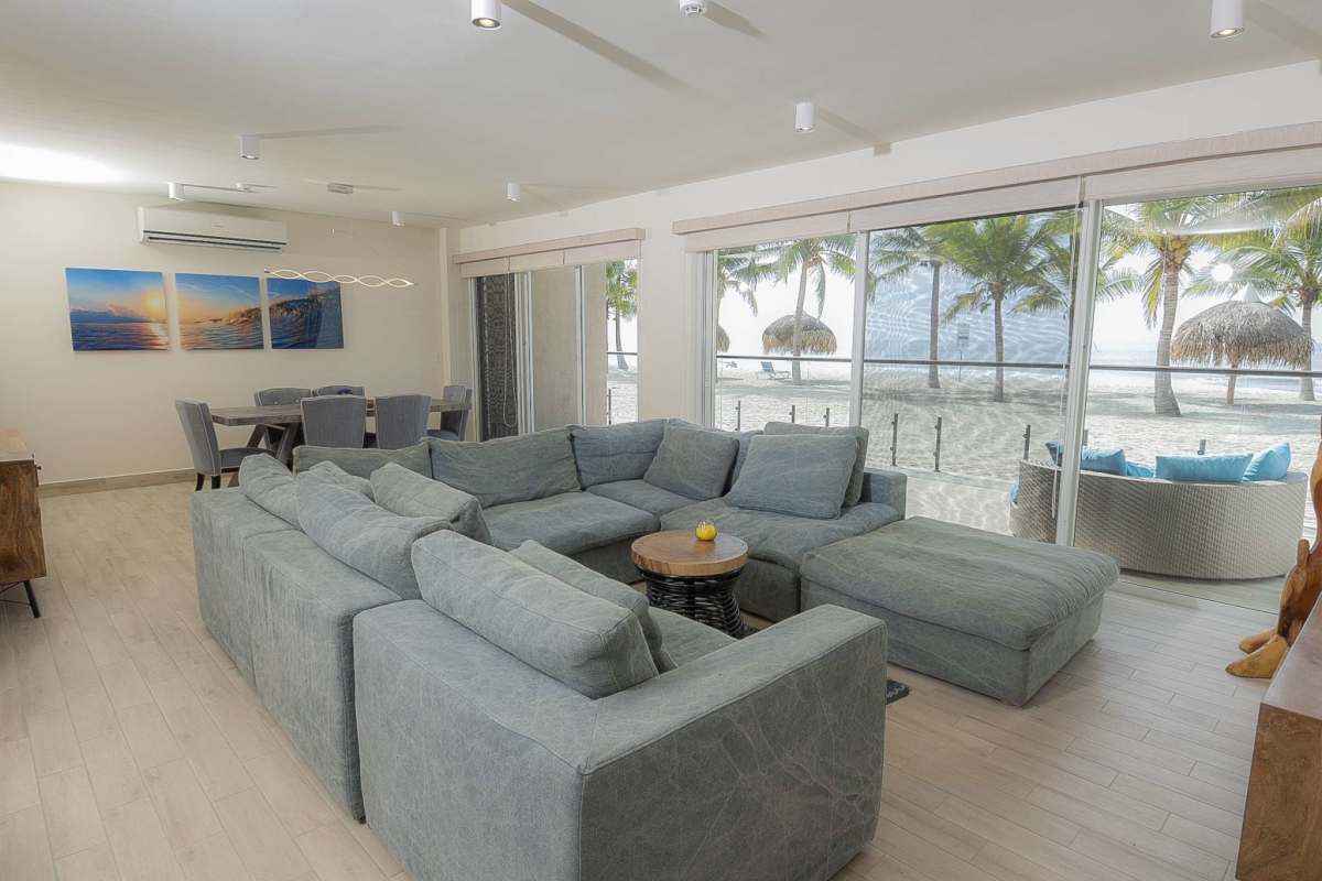 Spacious interior living room with dining area and panoramic ocean views at Olas del Mar Punta Chame