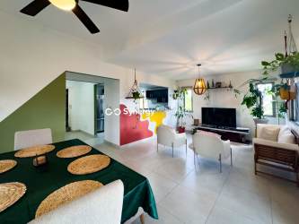 Bright open living dining room with large windows, AC, ceiling fans in Panama Pacifico duplex for sale