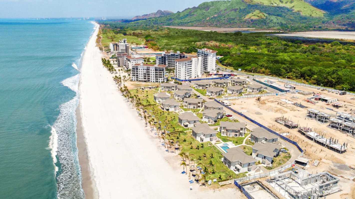 Aerial shot of oceanfront condos Playa Caracol with lush landscaping
