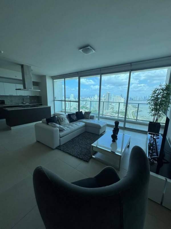 Open dining and living space with floor-to-ceiling windows and ocean views at PH Oceanaire Panama City