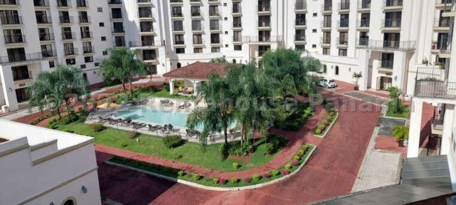 View of Mediterranean style complex with large central pool and gardens in PH Albrook Residences Panama