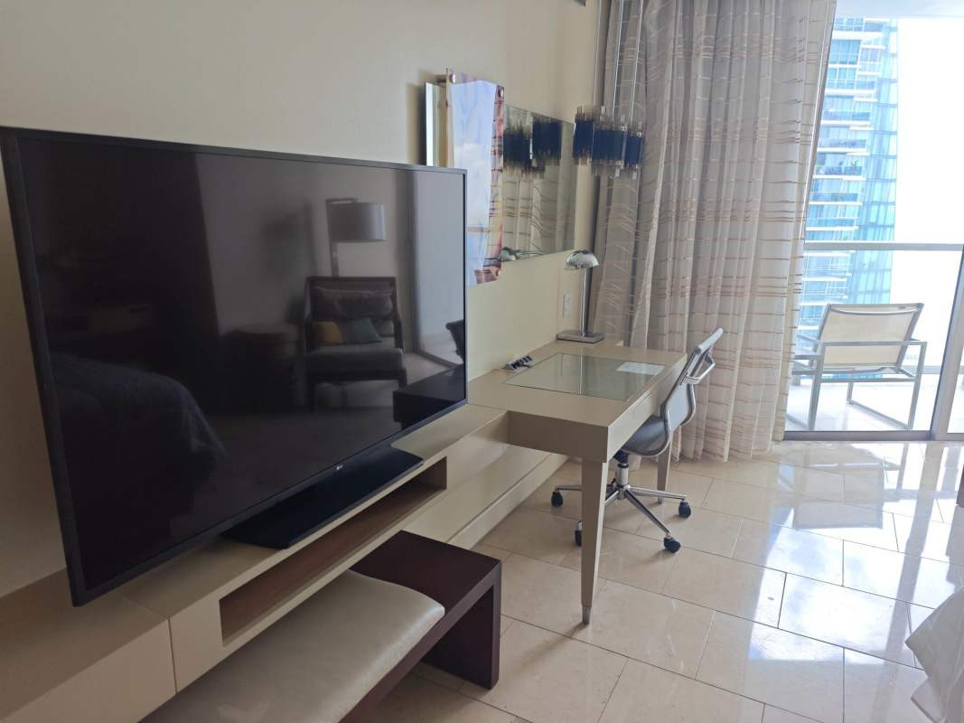 Private glass balcony of studio apartment with skyline and ocean views in Panama City