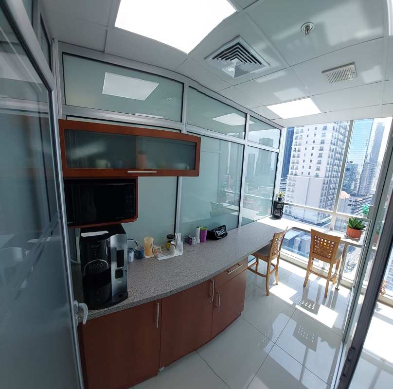 Modern kitchenette with appliances and dining table in PH BICSA Center Obarrio Panama