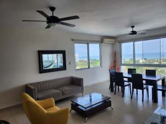 Open living and dining area with large windows oceanfront view in Playa Blanca apartment Panama