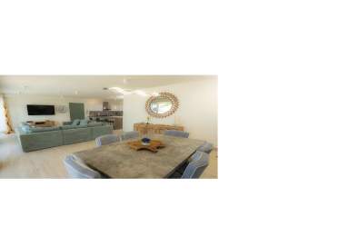 Modern kitchen with large island bar stools pendant lighting open plan at Olas del Mar Playa Caracol Panama