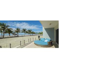 Living room with floor-to-ceiling windows ocean view coastal modern furnishings Olas del Mar Panama