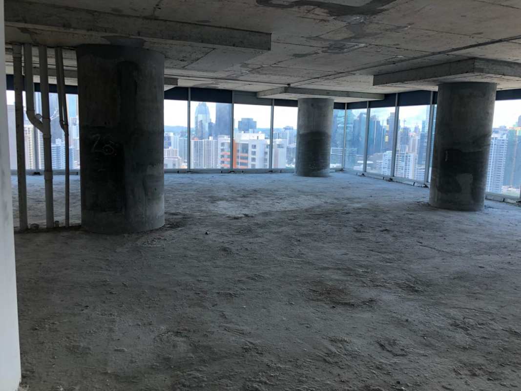Unfinished commercial space with floor-to-ceiling glass windows and city views at Ocean Business Plaza Panama