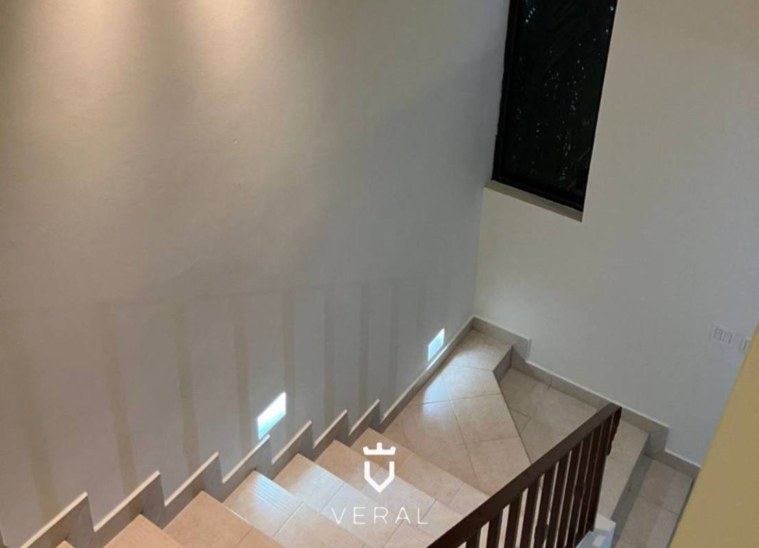 Modern marble staircase with wall lighting and window natural light residential Panama home