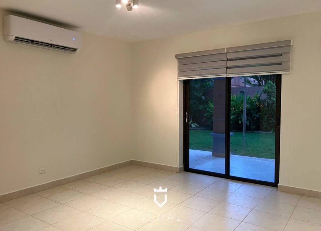 Indoor stairwell with marble floors, wooden railing, natural light in Versalles Panama home