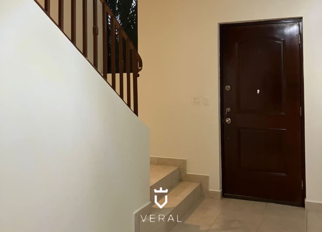 Duplex entry with marble flooring, wooden front door, staircase in Versalles Costa Sur Panama