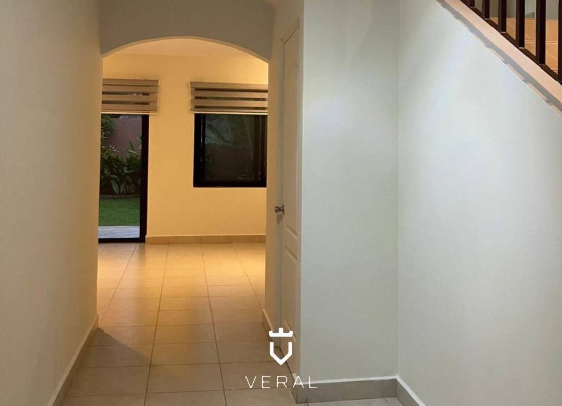 Bright living dining room with access to terrace and neutral marble floors in Panama home