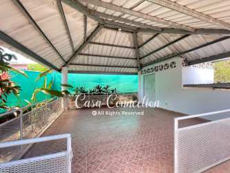 Spacious covered terrace overlooking fenced garden and traditional bohio in San Pablo Viejo David Panama