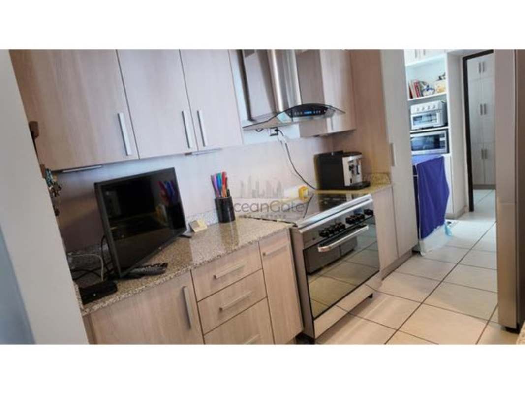 Kitchen with granite counters, stainless appliances, cabinets in PH Ocean Gate Panama