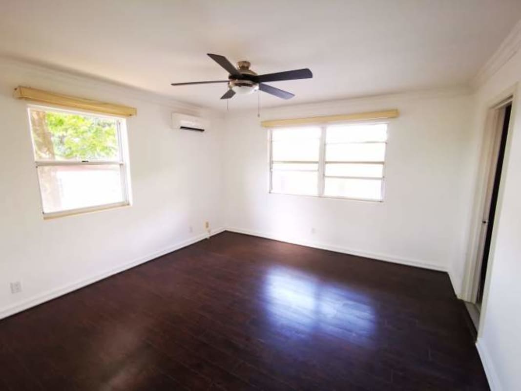 Kitchen with granite counters, wooden cabinets, double sink, bright space in Clayton apartment