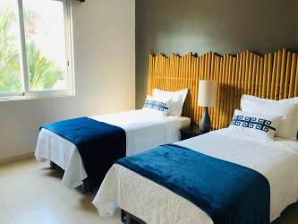 Second bedroom with large window and neutral decor at PH Balboa Bijao